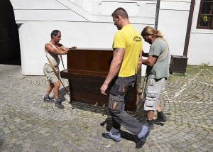 Professionals Moving a Piano